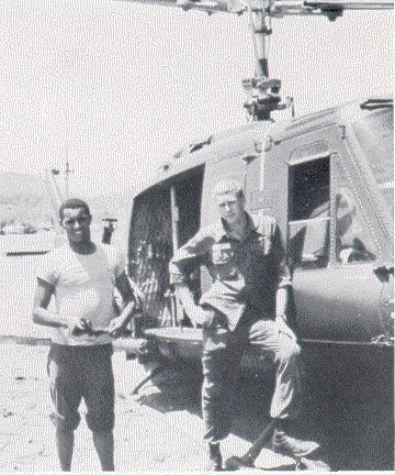 The Helicopter Wash. The crew chiefs took great pride in their aircraft and would get upset when we had to carry Nucbam.  Whenever possible they would get the pilot to fly the aircraft down to a river where it could be washed. These two fellas have been identified by Denis Kitner as Joe Ladson and Excel E. Norwood