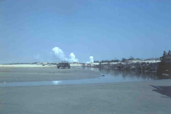 Looking inland from the beach at the stream that seperated the 161st and 14th Battalion HQ.  The white smoke in the distance is the still burning ammo dump that got blasted the night of Tet.